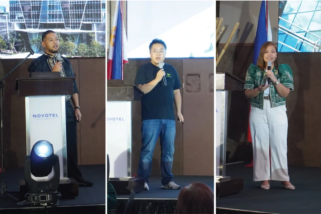 Representatives from Adata, Aula, and Edifier giving technical product presentations at the Novotel ballroom stage.